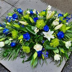 Blue Roses and White Lillies Casket Spray